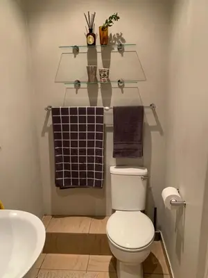 a bathroom with a toilet and a sink and towels at Treetops Studio in Cape Town