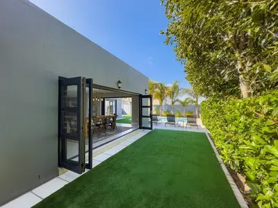 an open house with a green lawn at Peppertree Villa in Brackenfell