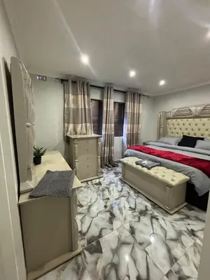 a bedroom with a bed with a red bedspread at Luxurious Family Home 2