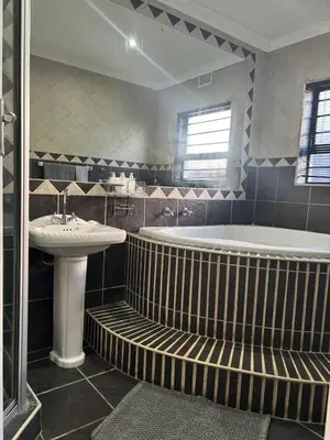 a bathroom with a tub and a sink at Luxurious Family Home 2