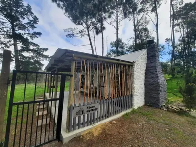 a fence with a gate in a yard at Stone Cottage in Grabouw
