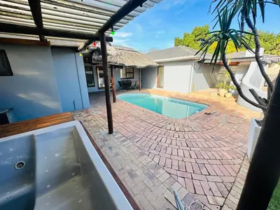 a swimming pool in the backyard of a house at Joy House in Cape Town