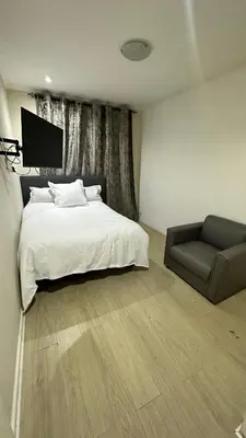 a bedroom with a bed and a couch at Joy House in Cape Town