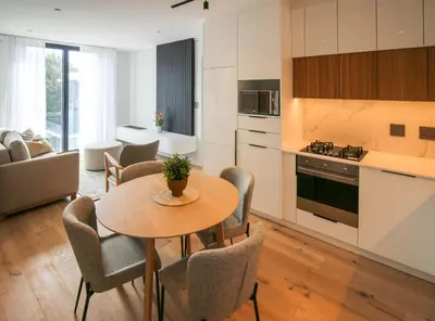 a kitchen and living room with a table and chairs at Charming Apartment in Cape Winelands District in Stellenbosch