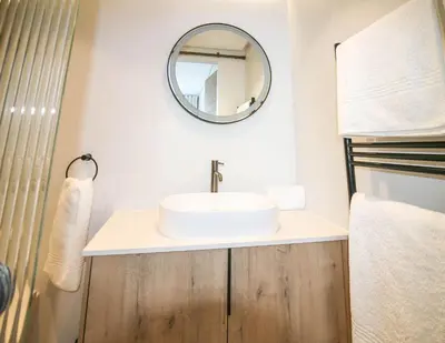 a bathroom with a sink and a mirror at Charming Apartment in Cape Winelands District in Stellenbosch