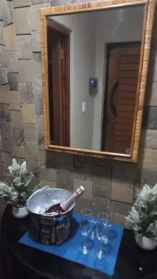 a mirror and a bowl on a table with glasses at Schubert Self Catering Accomodation in Brackenfell