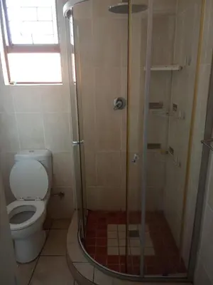 a bathroom with a shower with a toilet at Schubert Self Catering Accomodation in Brackenfell