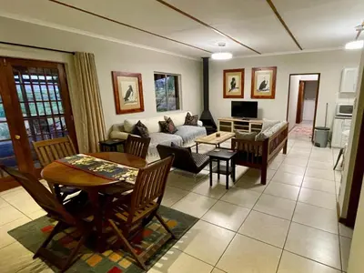 a living room with a couch and a table at Rivergrace Farm in Robertson