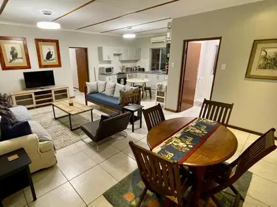 a living room with a table and a couch at Rivergrace Farm in Robertson