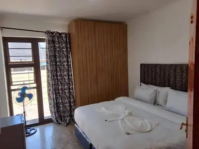 a hotel room with a bed and a window at Guest Lodge on 12 Duminy in Bellville