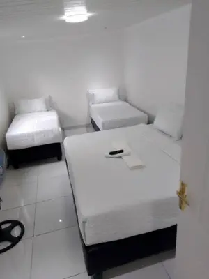 a room with two beds with a phone on it at Guest Lodge on 12 Duminy in Bellville