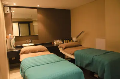 a hospital room with two beds and a mirror at Knightsbridge Luxury Apartments in Cape Town
