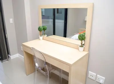 a dressing table with a mirror and a chair at Knightsbridge Luxury Apartments in Cape Town