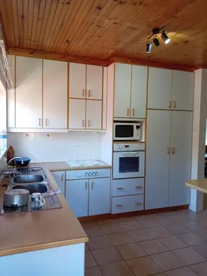 a kitchen with white cabinets and a stove top oven at Beyond Expectation in Avondale