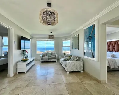 a living room with a view of the ocean at Ocean View in Hermanus