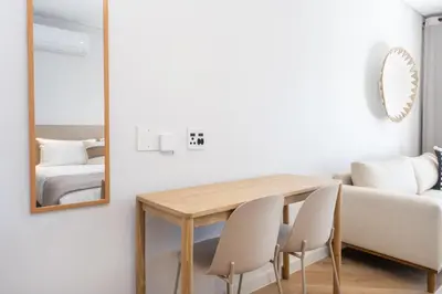a dining room with a table and chairs and a mirror at Paarl Superior Studio 230 With Onsite Parking in Paarl