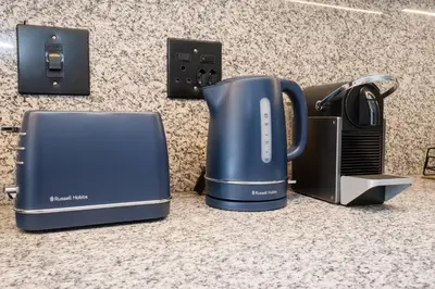 a blue coffee pot sitting on top of a counter at Paarl Superior Studio 231 - With Onsite Parking & Comforts in Paarl