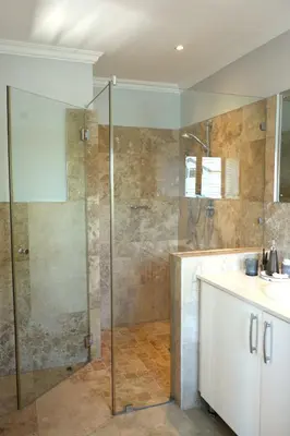 a bathroom with a glass shower and a sink at Modern Family Golf Lodge in Winelands Paradise in Paarl