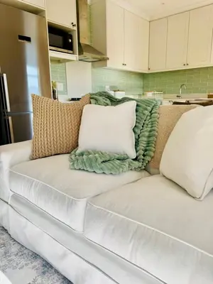 a white couch with pillows on it in a kitchen at Villa Mignon in Franschhoek