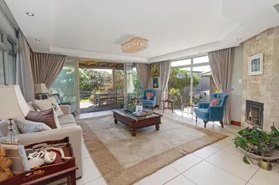 a living room with a couch and a fireplace at Dune Pavillion Beach Villa-Where the Ocean Meets the Mountain in Cape Town