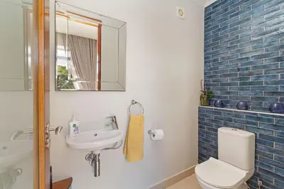a bathroom with a toilet and a sink and a mirror at Dune Pavillion Beach Villa-Where the Ocean Meets the Mountain in Cape Town