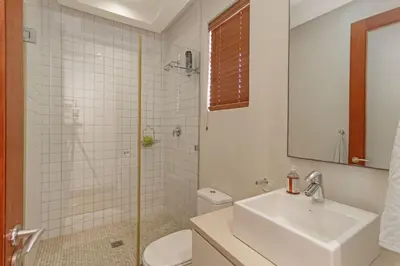 a bathroom with a sink and a toilet and a shower at Dune Pavillion Beach Villa-Where the Ocean Meets the Mountain in Cape Town