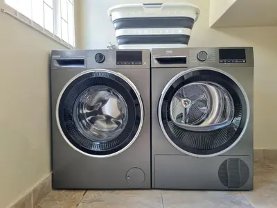 two washing machines sitting next to each other in a room at Paradise Tide - 4 Bedroom Beachfront home with Private Pool in Cape Town