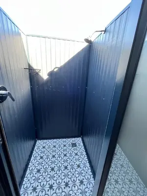 a shadow of a person in a shower stall at Leliefontein Eco Cottage and Glamping in Paarl