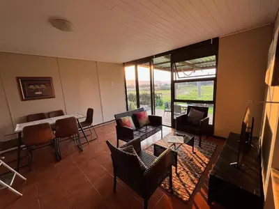 a living room with a couch and chairs and a table at Leliefontein Eco Cottage and Glamping in Paarl