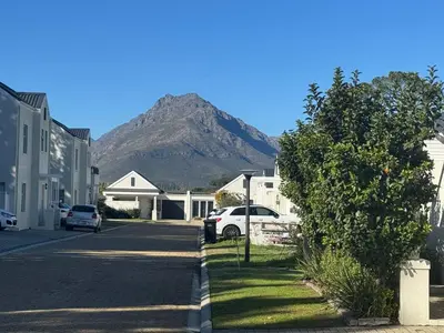 a street in a town with a mountain in the background at Avalon 4 Bed 4 Bath House in residential security Estate in Stellenbosch