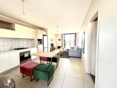 a kitchen with a table and chairs in a room at Luxe watersedge apartment in Cape Town
