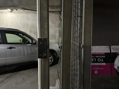 a parking meter in a parking garage with a car at 109 on Oudehoek in Stellenbosch