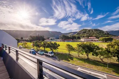 a view from a balcony of cars parked on a road at Oakwood Hermanus in Hermanus
