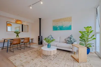 a living room with a couch and a table at Oakwood Hermanus in Hermanus