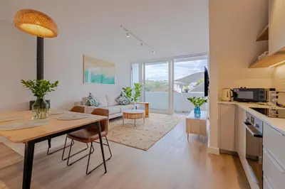a kitchen and living room with a table and a dining room at Oakwood Hermanus in Hermanus