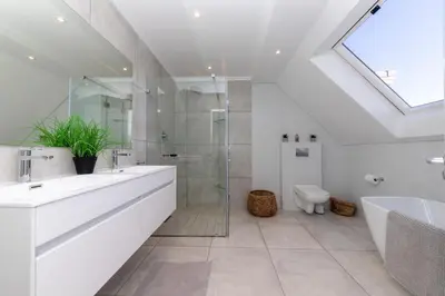 a bathroom with a sink and a shower and a toilet at Dolphin Beach C110 Beachfront Beauty in Cape Town