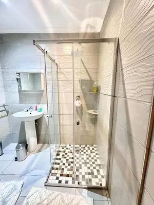 a bathroom with a shower and a sink at Apartment in Bellville - self-catering in Bellville