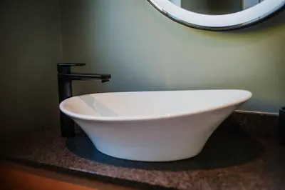 a bathroom with a white bowl sink and a mirror at Mountain-View Stay, Aircon, WiFi, Parking in Somerset West