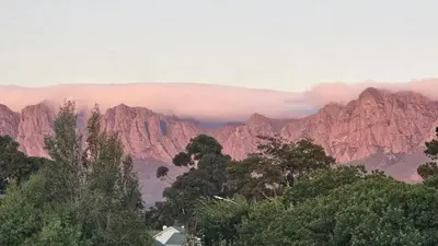 a view of a mountain range with clouds in the background at Mountain-View Stay, Aircon, WiFi, Parking in Somerset West