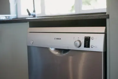 a stainless steel dishwasher in a kitchen with a counter at Mountain-View Stay, Aircon, WiFi, Parking in Somerset West