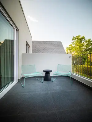 two chairs and a table on a balcony at Mountain-View Stay, Aircon, WiFi, Parking in Somerset West