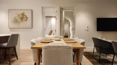 a dining room with a table and chairs at De Waal Grandeur Apartment in Stellenbosch