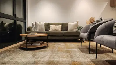 a living room with a couch and a table at De Waal Grandeur Apartment in Stellenbosch