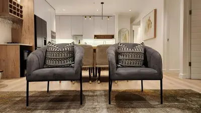 a dining room with two chairs and a table at De Waal Grandeur Apartment in Stellenbosch