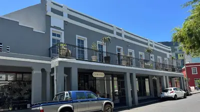 a blue car parked in front of a building at Obs Centre The Lookout in Cape Town