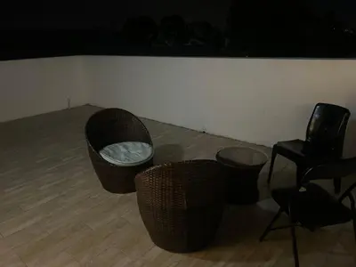 a room with two chairs and two tables and chairs at Jorash Guesthouse in Cape Town