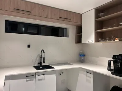 a kitchen with white cabinets and a sink at Jorash Guesthouse in Cape Town