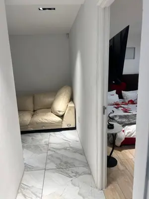 a living room with a couch in the corner of a room at Jorash Guesthouse in Cape Town