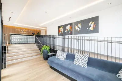 a lobby with a blue couch in a building at 317 Riverlands - Lux 1 bedroom Apartment in Cape Town