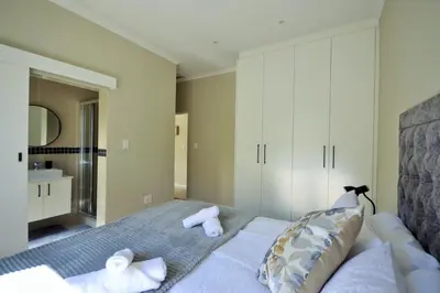 a bedroom with a bed with towels on it at Tweespruit Estate - Stellenbosch- 3 Bedroom House in Stellenbosch